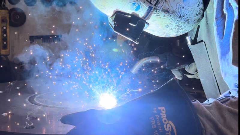 Acumen Welder in gloves blue light